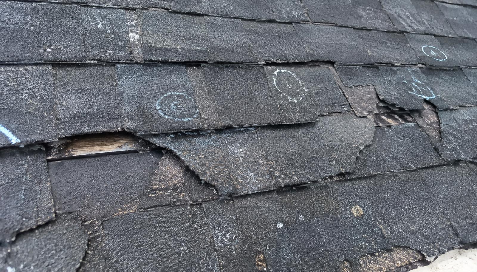 Roof shingles marked during a damage inspection